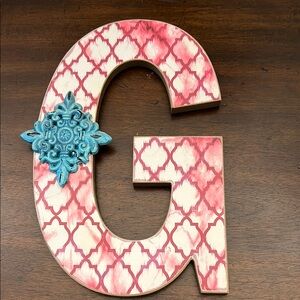 Decorative Letter G with Pink Pattern and Blue Accent